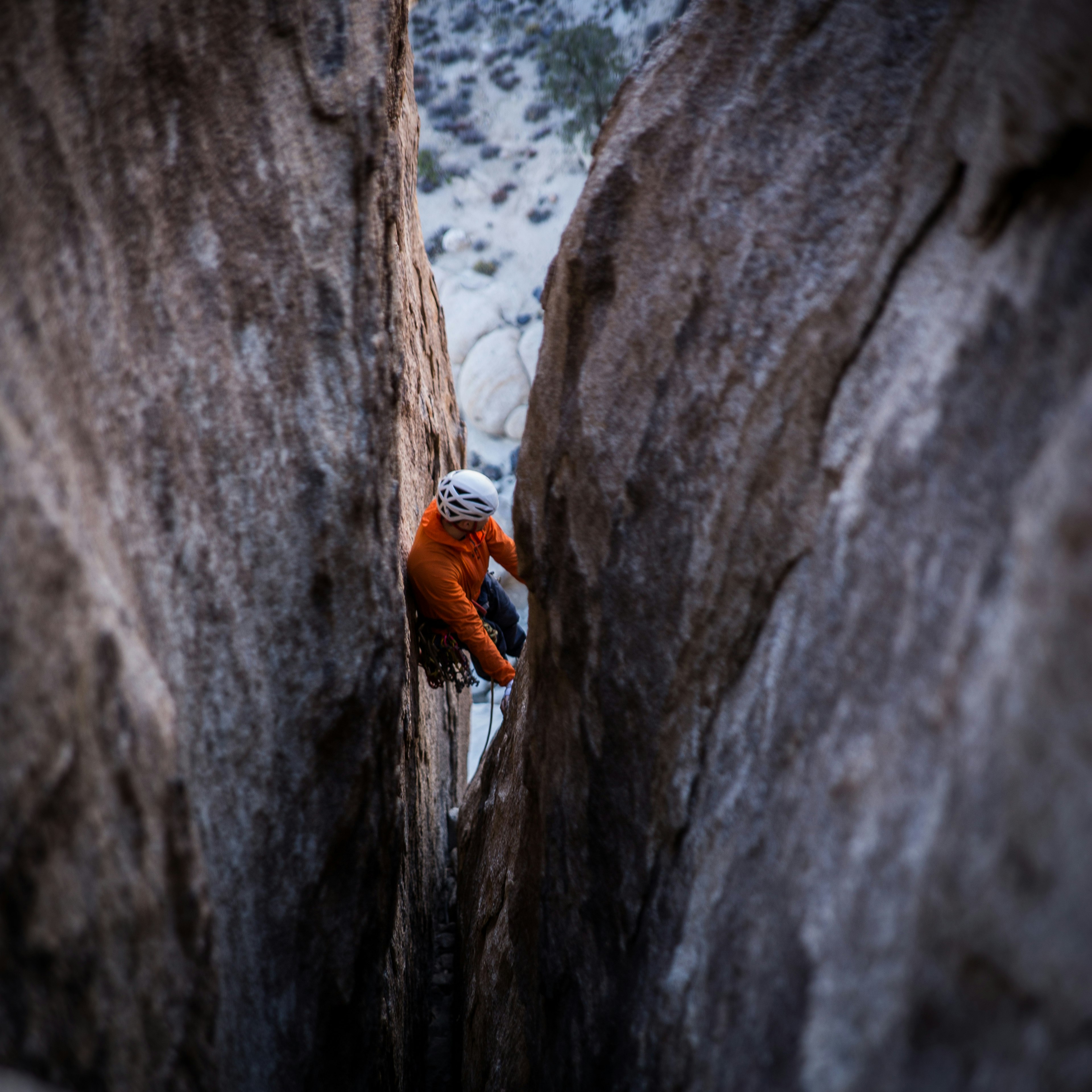 man climbing on rock monument